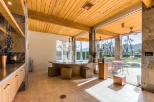 an open kitchen with a table and a large window at Morning Springs Mirage in Rancho Mirage
