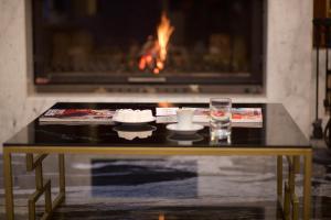 a coffee table in front of a fireplace at My Dream Istanbul Hotel in Istanbul