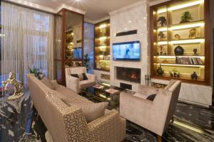 a living room with couches and a tv and a fireplace at My Dream Istanbul Hotel in Istanbul +75 photos
