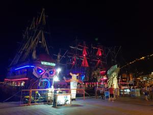 a carnival with a pirate ship at night at Granada City Alanya Luxury Appartment 800м от пляжа Клеопатра in Alanya