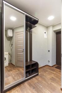 a large mirror in a room with a bathroom at "Domino" 4 Apartments in Kharkiv