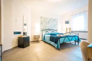 a bedroom with a bed with a blue blanket at Valle dei Mulini - Lake Como in Bellano