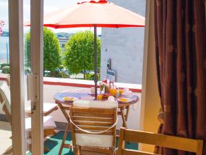 a table with an umbrella on a balcony at Seawinds Bed and Breakfast in Killybegs
