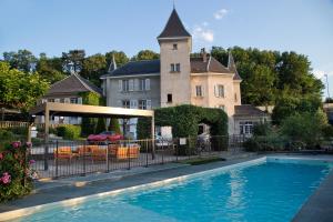 a house with a swimming pool in front of a house at Château Hôtel, Restaurant & Spa De La Commanderie in Eybens +47 photos