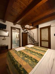 a bedroom with a large bed with a staircase at La Cascina per un Sogno in Tornimparte