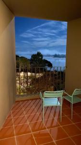 a balcony with a bench and a view of the ocean at Vale do Gaio Hotel in Torrão