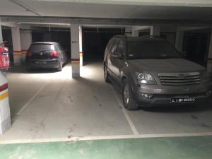 two cars are parked in a parking garage at Moderne & fabuleux appart in Tunis