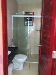 a bathroom with a toilet and a sink at Vila Mulungu Flats in Mulungu +14 photos