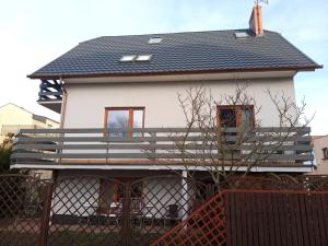 a house with a black roof on top of it at Willa Róż in Międzyzdroje