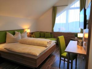 una camera d'albergo con un letto, un divano e un tavolo di Hotel Mauernböck a Rottenbach
