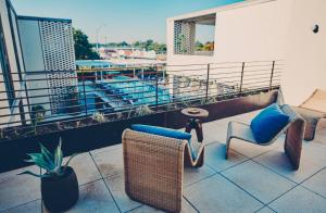 uma varanda com cadeiras e um vaso de plantas num edifício em South Congress Hotel em Austin