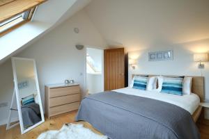 a bedroom with a large bed and a mirror at Skye Lair in Teangue