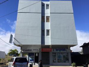 a building with a car parked in front of it at La Péninsule Town Apartment Curepipe No 4 in Curepipe