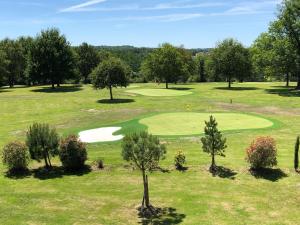 an overhead view of a golf course with a green at Hôtel et Restaurant Domaine de l'Orangerie in Bonnat