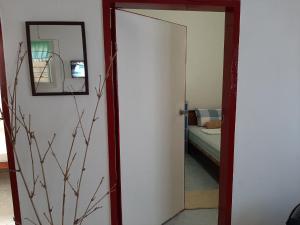 a door leading into a bedroom with a mirror at Kalinaw Stay and Café in El Nido