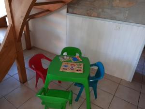 a table and four chairs in a room at La Sénonaise in Sens sur Seille +25 photos