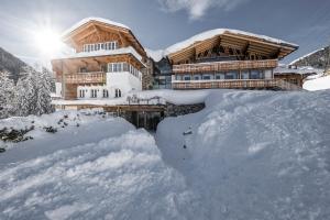a pile of snow in front of a house at Mooser Hotel in Sankt Anton am Arlberg