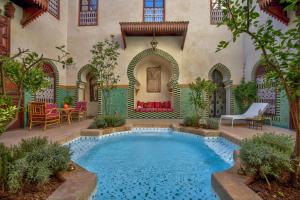 a swimming pool in the middle of a house at Riad Aventurine in Marrakech