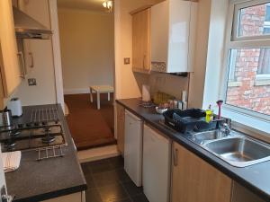 a kitchen with a sink and a counter top at South Shield's Hidden Gem Emerald Apartment sleeps 6 Guests in South Shields