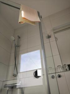 a bathroom with a shower with a window at Hotel Mauernböck in Rottenbach