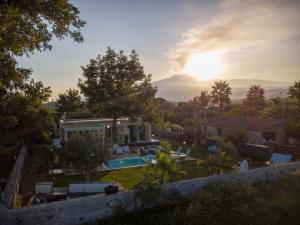 a villa with a swimming pool and a house at T Villa in Calatabiano