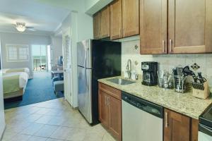 a kitchen with a sink and a refrigerator at Club Wyndham Towers on the Grove in Myrtle Beach