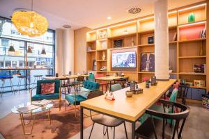 a restaurant with tables and chairs in a room at ibis Styles Pforzheim in Pforzheim