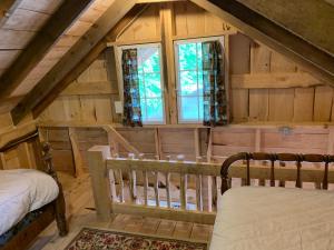 an attic bedroom with a bed and a window at Blue Lodge in Hesston