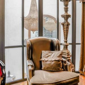 a chair with a pillow in a room with windows at Hôtel Chateaubriand in Paris