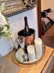 a tray with a bottle of wine and candles on a table at Grange Farm Lodge in Ripon
