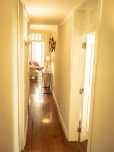 a hallway with a room with a hard wood floor at São Lázaro Appartment by Demsimmo in Lisbon