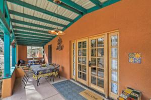 a dining room with a table and chairs on a patio at Vibrant Casa Paloma 2 with Patio - Near Vineyards! in Patagonia