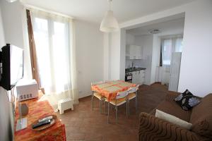 a living room with a couch and a table at Orchidea Rooms & Suites in Civitanova Marche