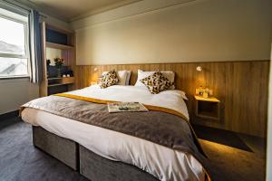 a bedroom with a large bed and a window at The Old Quarter Townhouse in Limerick