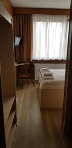 a bedroom with a bed and a window at Central-Hotel Tegel in Berlin