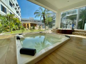 a jacuzzi tub in the middle of a building at Scaini Palace Hotel in Arroio do Silva