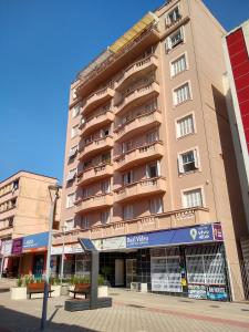 a tall building with balconies on the side of it at Quarto exclusivo em APTO compartilhado in Novo Hamburgo