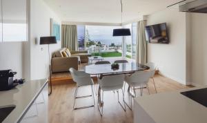 a kitchen and living room with a table and chairs at Flamingo Beach Mate in Adeje