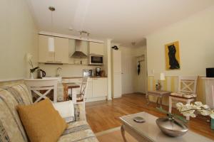 a living room and kitchen with a couch and a table at Residenz Weedkroog in Timmendorfer Strand