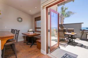 a room with a balcony with a table and chairs at 358 Front Street in Avila Beach