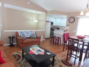 a living room and kitchen with a couch and a table at 618 Airpark in Oceano