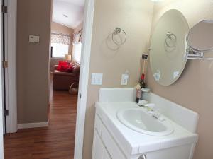 a bathroom with a white sink and a mirror at 618 Airpark in Oceano +33 photos