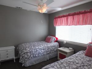 a bedroom with two beds and a ceiling fan at 618 Airpark in Oceano