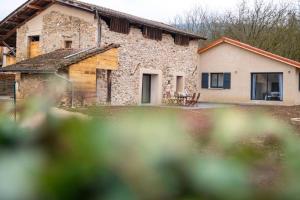 a large stone house with a yard in front of it at La grange au pied du Vercors Piscine et SPA privatifs in Saint-Romans