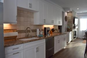 a kitchen with white cabinets and a sink at 245 San Miguel in Avila Beach