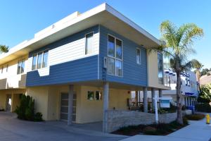 a blue and white building with palm trees at 245 San Miguel in Avila Beach