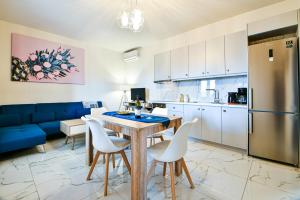 a kitchen and dining room with a table and chairs at Koukounari Luxury Apartments in Vathí