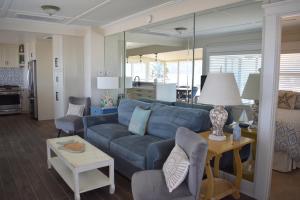 a living room with a blue couch and a table at 75 San Antonia in Avila Beach