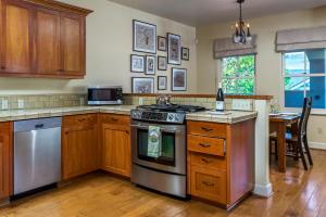 a kitchen with wooden cabinets and a stove top oven at 28 San Miguel in Avila Beach