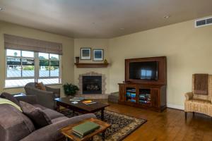 a living room with a couch and a television at 28 San Miguel in Avila Beach